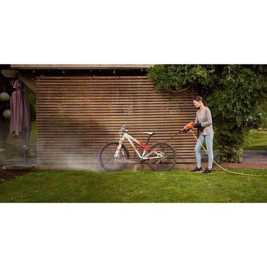Cordless Power Cleaner Kit being used by person to clean bicycle.