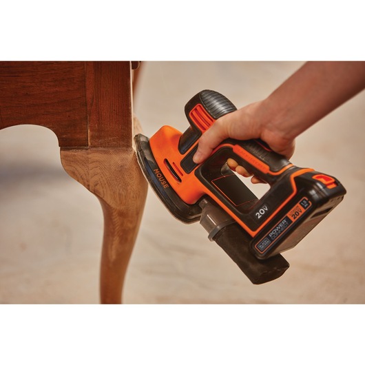 MOUSE Cordless Sander being used to sand table legs.