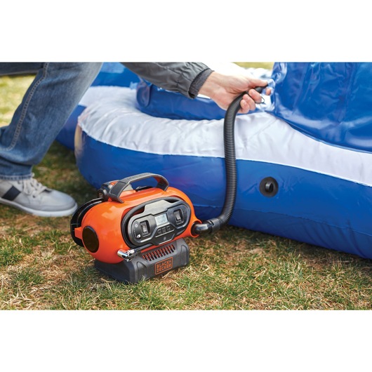 Multi Purpose Inflator being used to inflate campsite furniture.