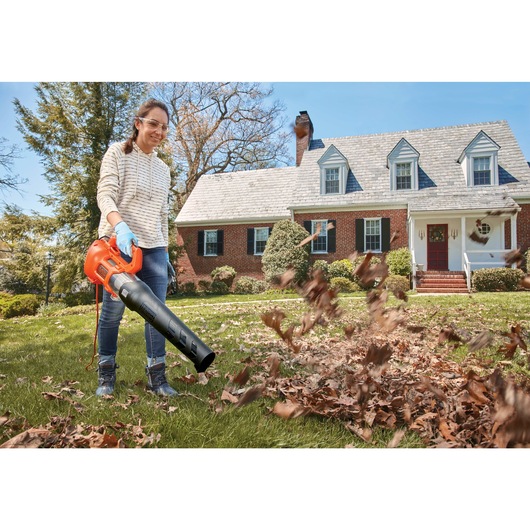 9 AMP Electric Axial Leaf Blower being used by a person in yard.