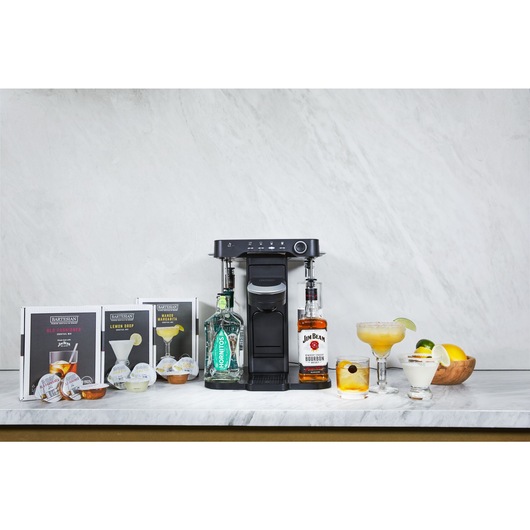 bev by BLACK+DECKER™ cocktail maker on a marble kitchen counter with an assortment of garnished drinks and corresponding capsules
