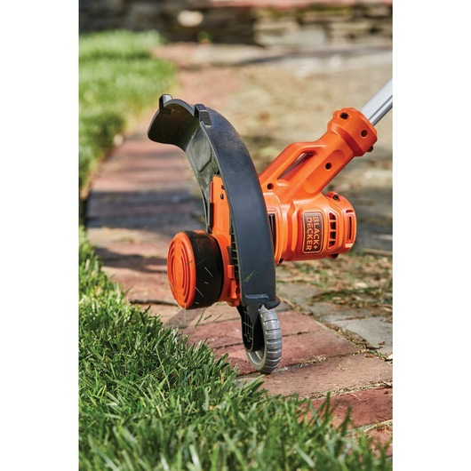 Wheeled edge guide feature of 6.5 Amp 14 inch AFS electric string trimmer hedger.