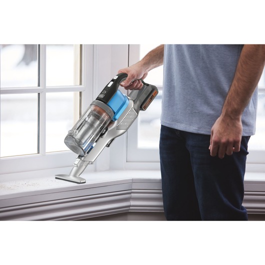 Powerseries extreme cordless stick vacuum cleaner being used by a person.