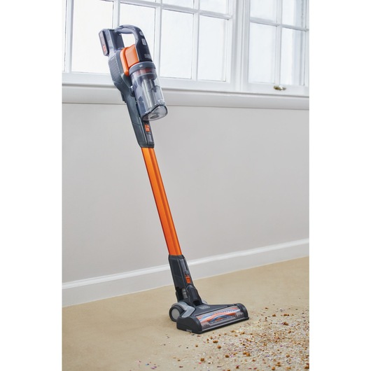 POWER SERIES Extreme cordless stick vacuum cleaner standing besides a wall.