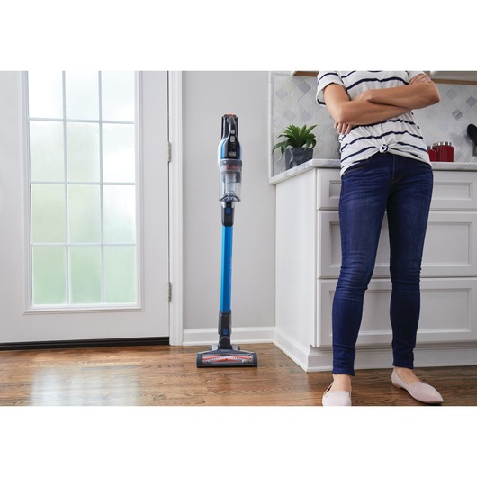 Powerseries extreme pet cordless stick vacuum cleaner being placed inside a house.