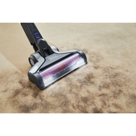 POWER SERIES Extreme Pet Cordless Stick Vacuum Cleaner being used to clean pet fur from carpet.