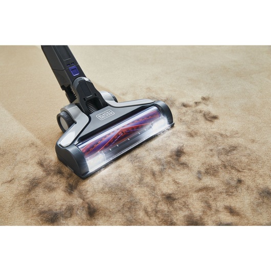 POWER SERIES Extreme Pet Cordless Stick Vacuum Cleaner being used to clean pet hair from rug.