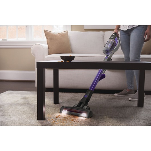 Powerseries extreme pet cordless stick vacuum cleaner being used to clean floor.