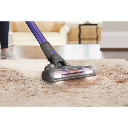 Powerseries extreme pet cordless stick vacuum cleaner being used by a person.