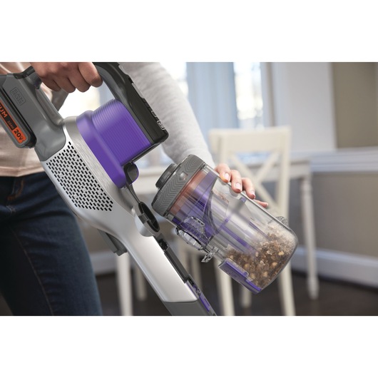 Closeup of POWER SERIES Extreme Pet Cordless Stick Vacuum Cleaner featuring front facing dustbin that empties easily with one touch.