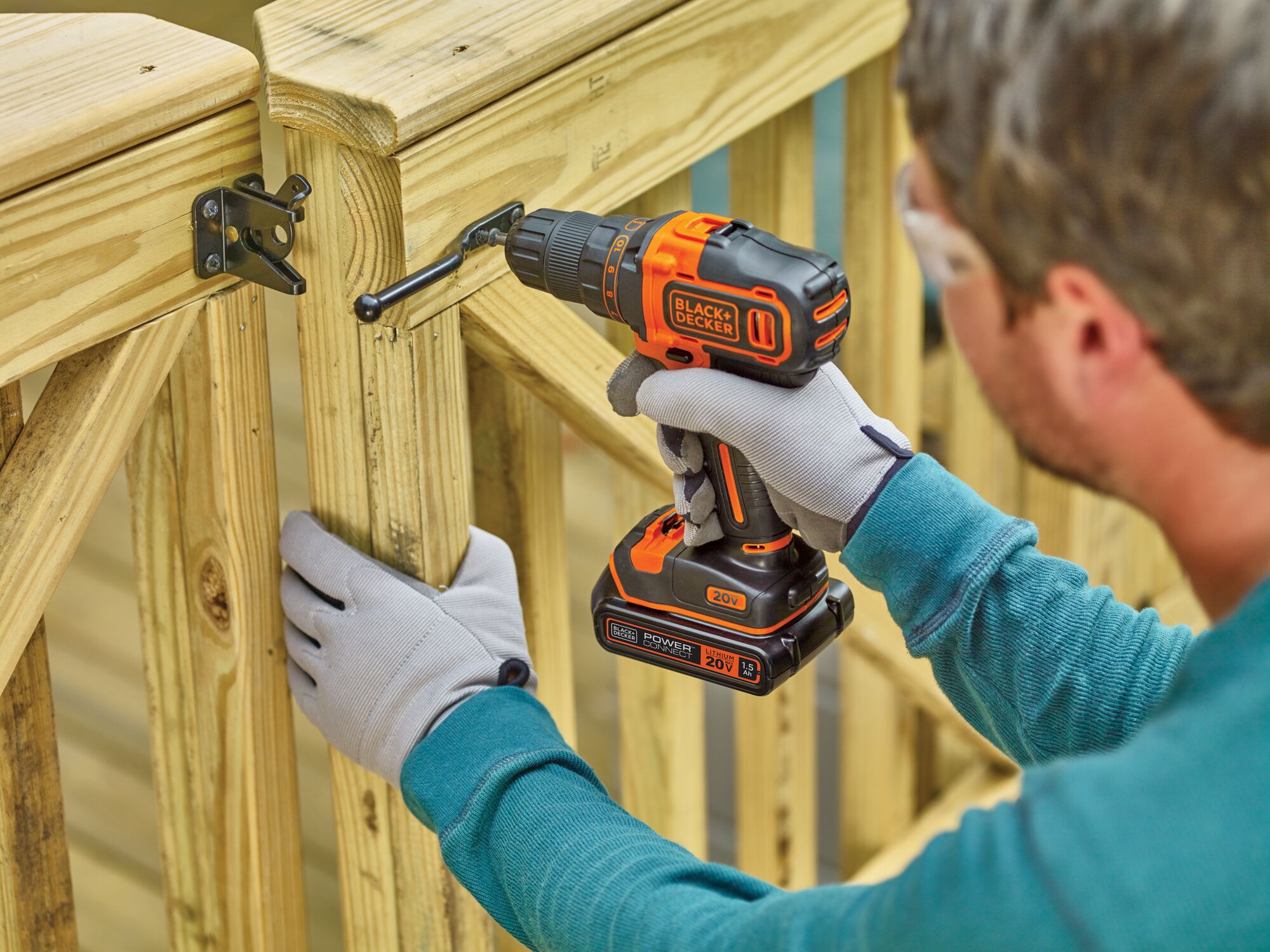 20 volt MAX lithium 2 speed drill driver being used by a person to fix a catch on wood.