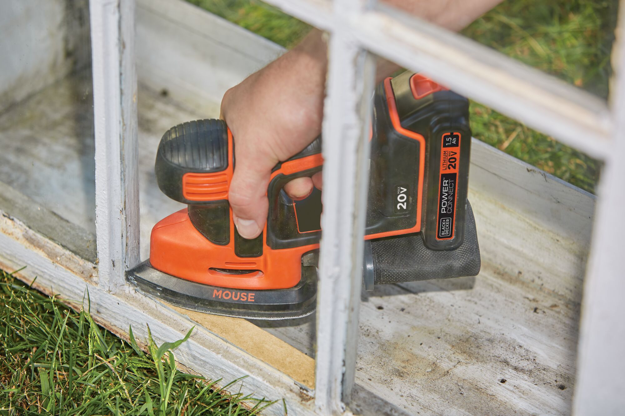MAX MOUSE Cordless Sander being used to refinish wooden frame structure.