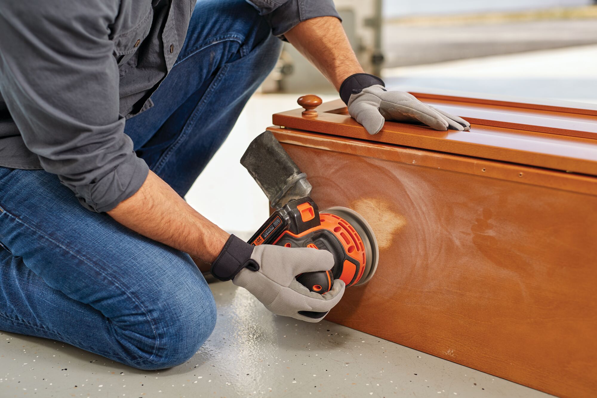 Cordless Random Orbital Sander being used to sand wooden structure.