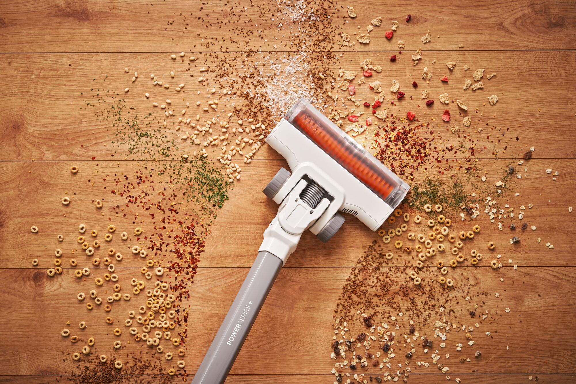 POWERSERIES Cordless Stick Vacuum being used to clean mess on a floor.