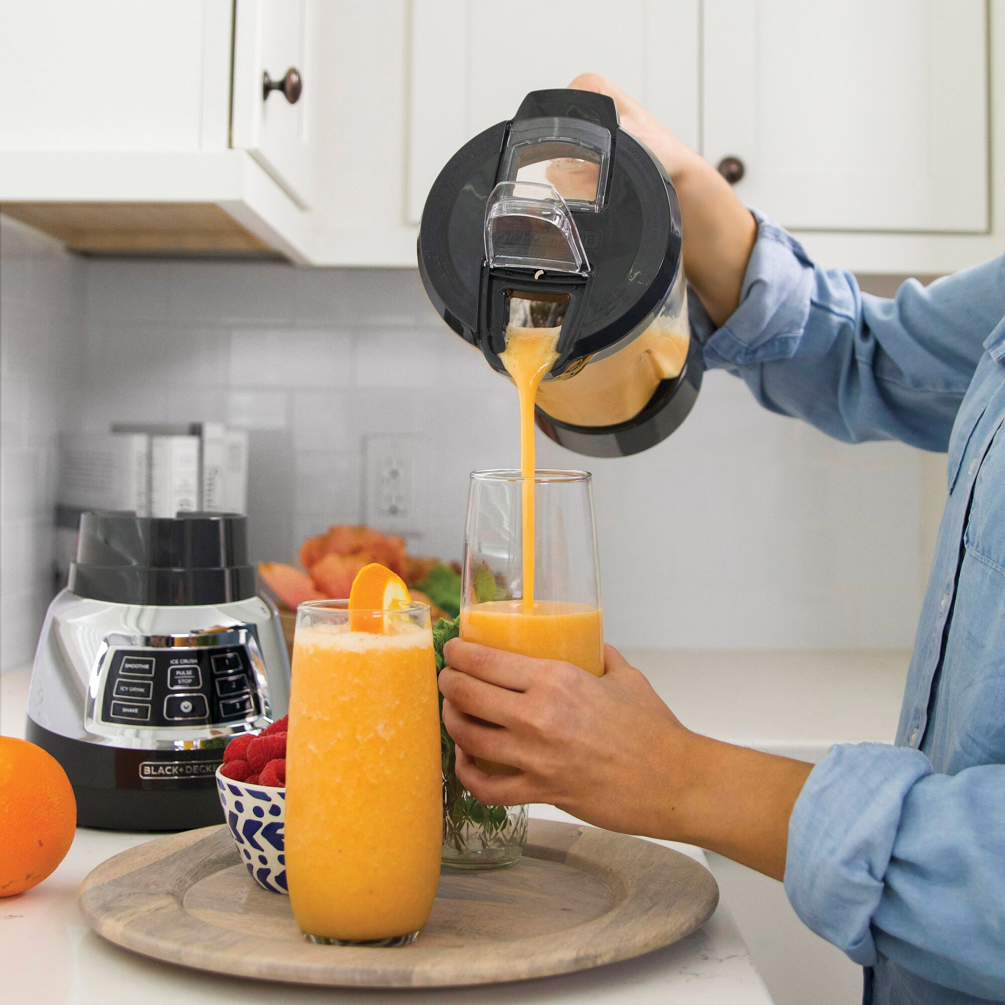 Orange Juice being poured from Quiet Blender with Cyclone Glass Jar into glass.