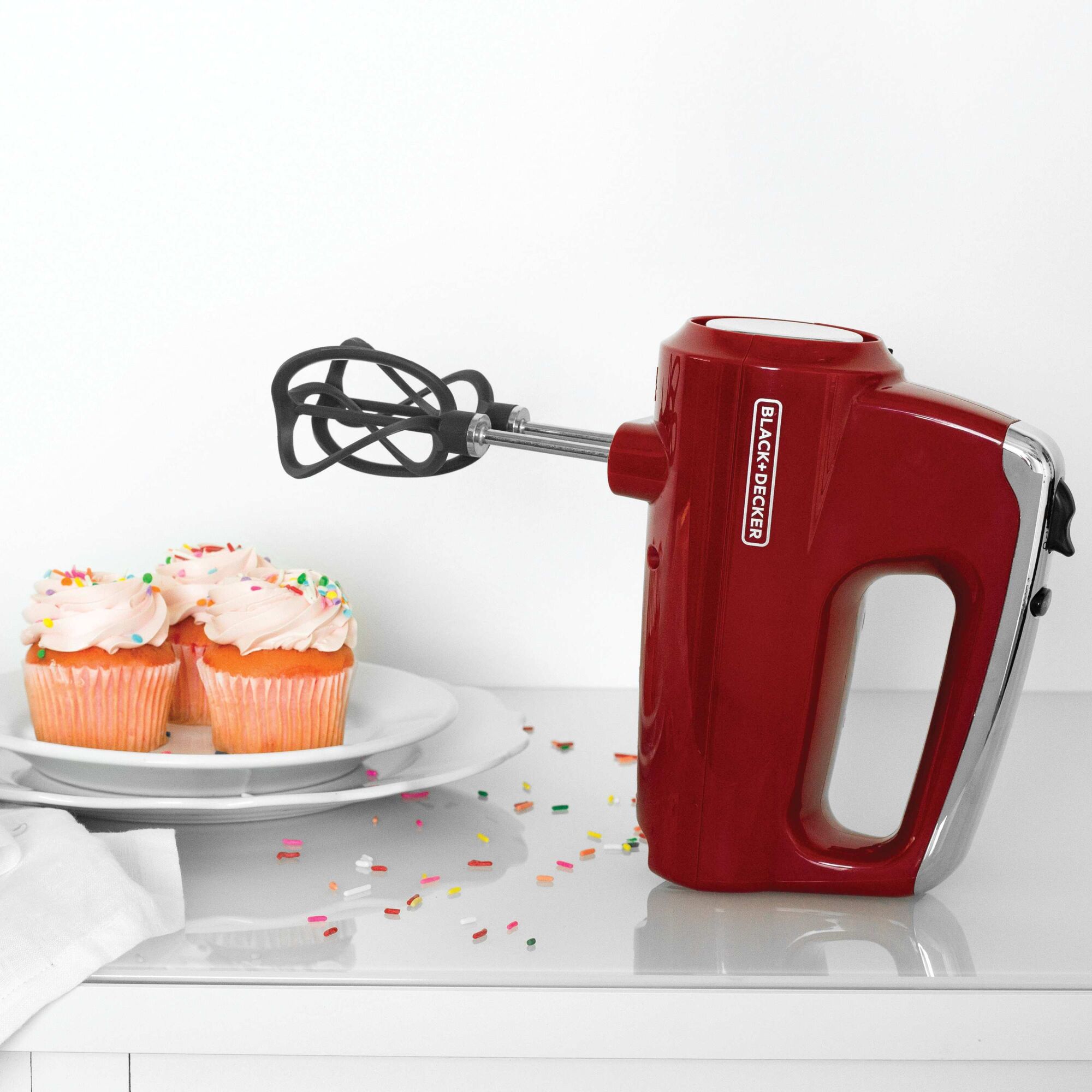 Helix performance premium 5 speed hand mixer with ready to eat frosted cupcakes on kitchen counter.