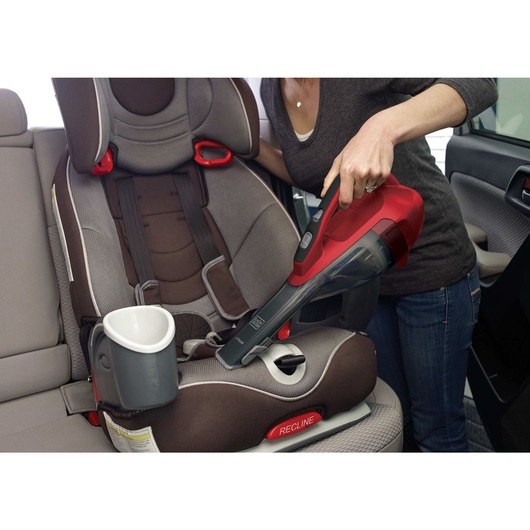 Dustbuster advanced clean cordless hand vacuum being used to clean car seats.