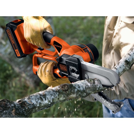 Lithium Alligator Lopper being used to cut branch.