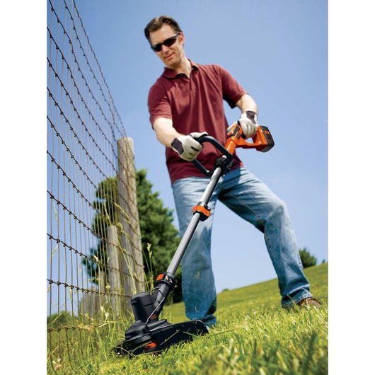 40 Volt Cordless String Trimmer with POWERCOMMAND being used by a person on grass.