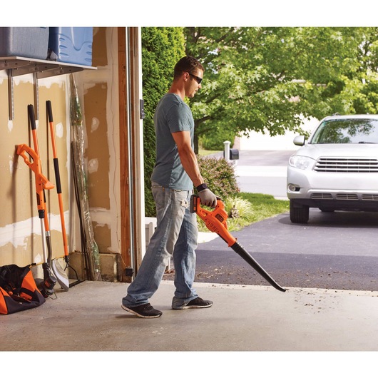 20 volt max lithium sweeper being used by a person.