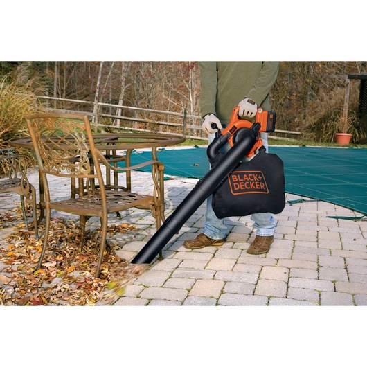 40 volt MAX lithium sweeper vacuum being used to clean leaves and debris outdoors.