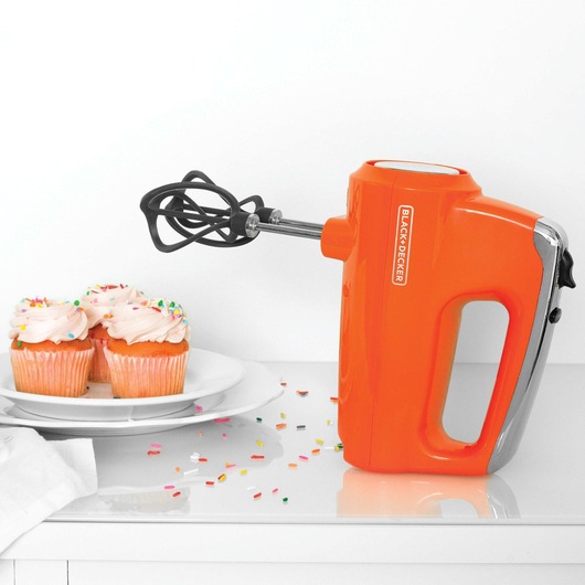 Helix Performance Premium Hand Mixer 5 Speed Mixer placed on shelf with cupcakes.