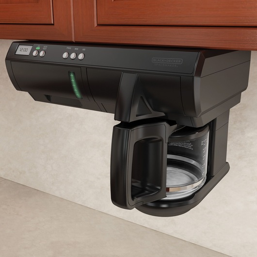 Black and decker programmable coffee maker fixed underneath a wooden cabinet.