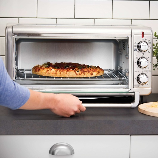 BLACK and DECKER Extra Wide Crisp N Bake Air Fry Toaster Oven being used to make pizza.